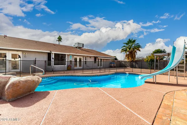 a view of swimming pool with outdoor seating