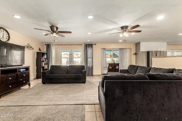 a living room with furniture and a ceiling fan