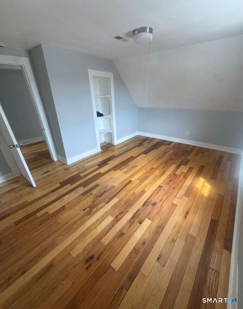 7 Armstrong Place Bridgeport, CT 06608 - Photo 4 of 9 a view of empty room with wooden floor and fan