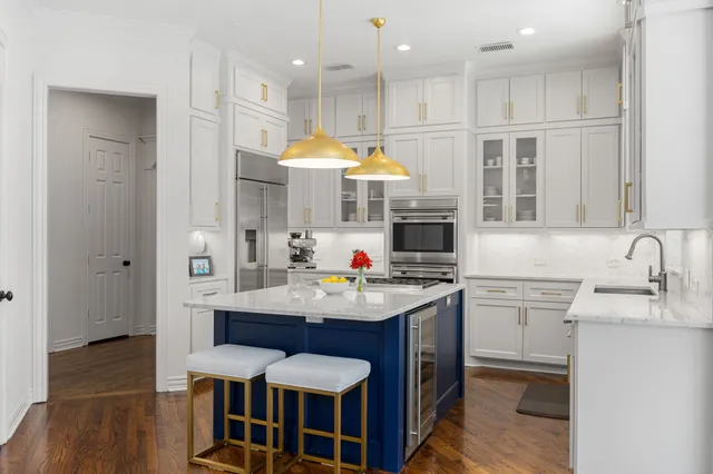 a kitchen with stainless steel appliances granite countertop a stove and a sink
