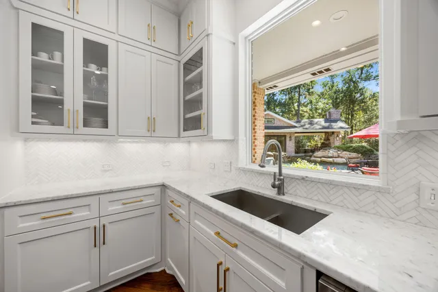 a living room with fireplace furniture and a large window