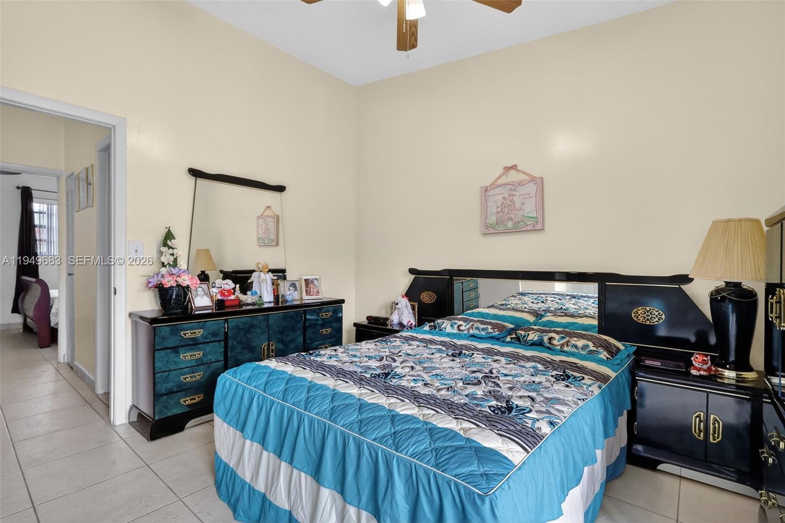 2224 West 53rd Place, Unit 2224 Hialeah, FL 33016 - Photo 18 of 27 a bedroom with a bed and a table in it