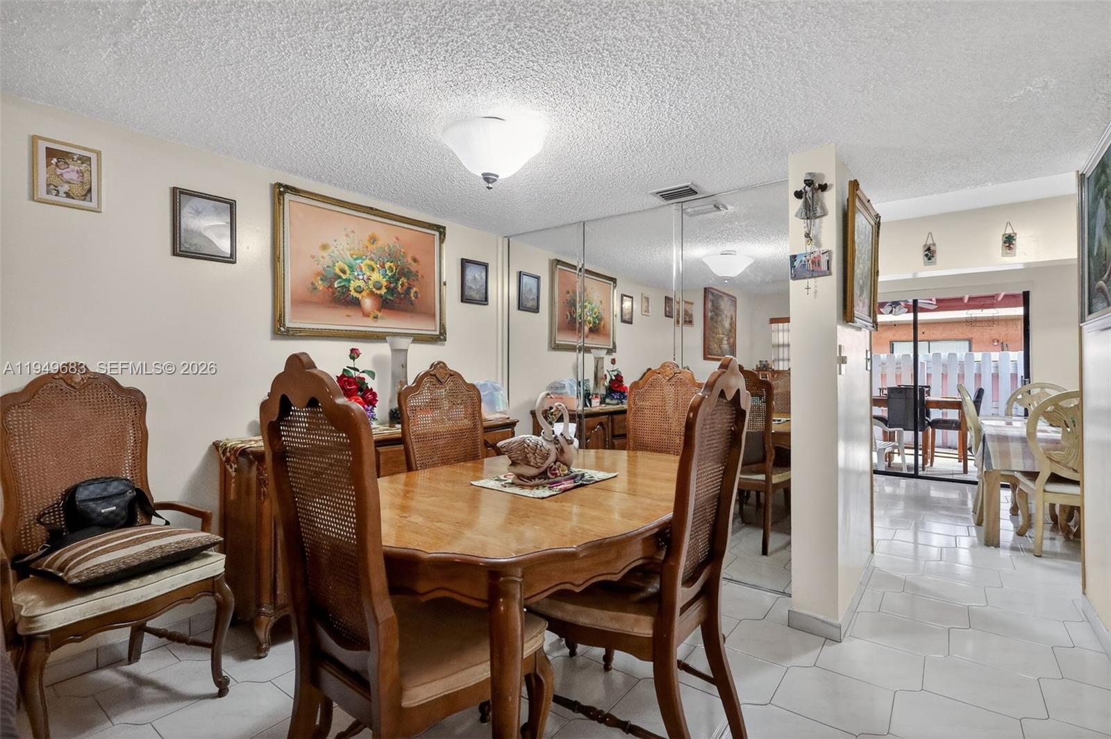 2224 West 53rd Place, Unit 2224 Hialeah, FL 33016 - Photo 8 of 27 a view of a dining room with furniture and chandelier