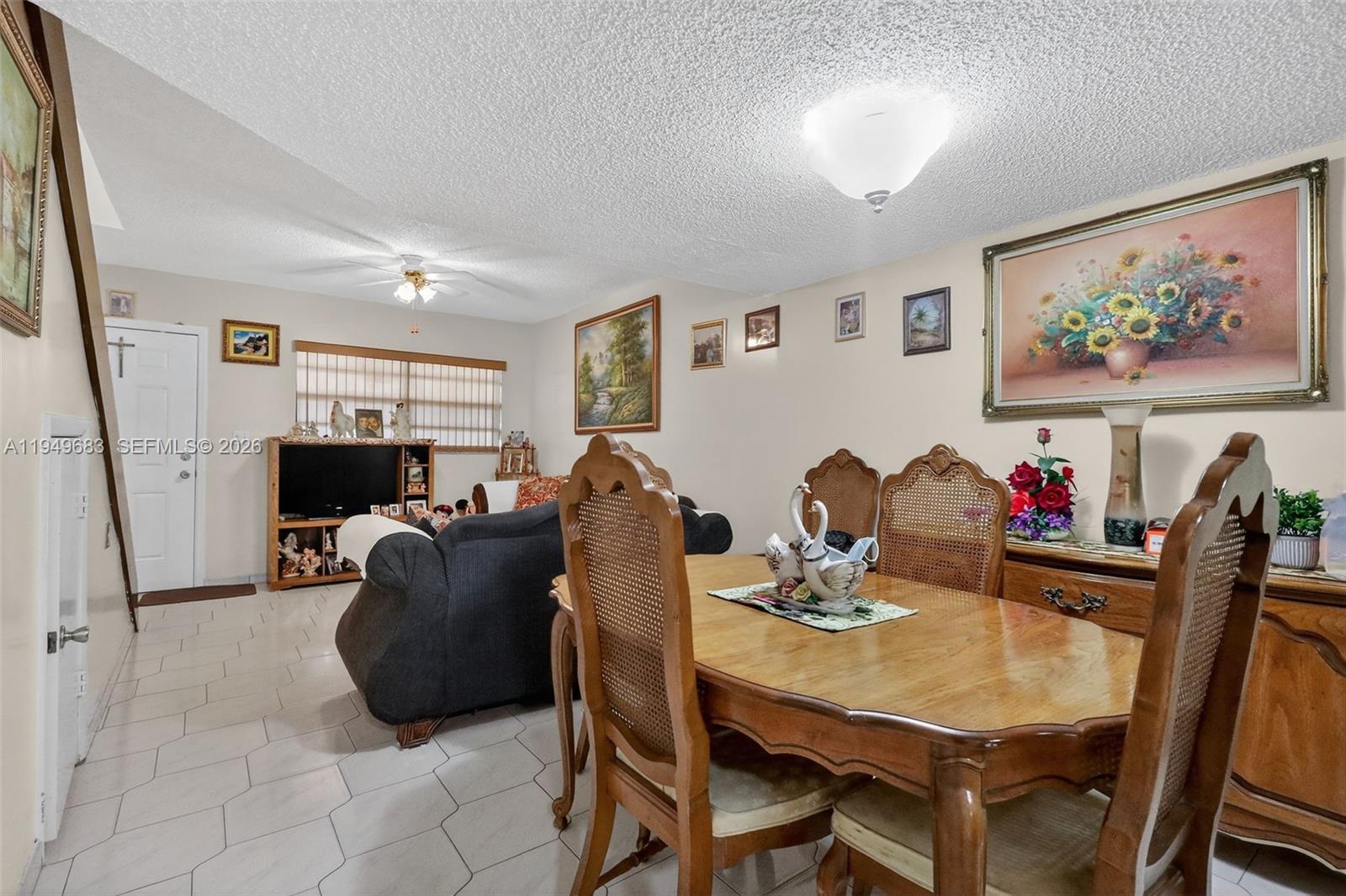 2224 West 53rd Place, Unit 2224 Hialeah, FL 33016 - Photo 9 of 27 a view of a dining room with furniture and a livingroom