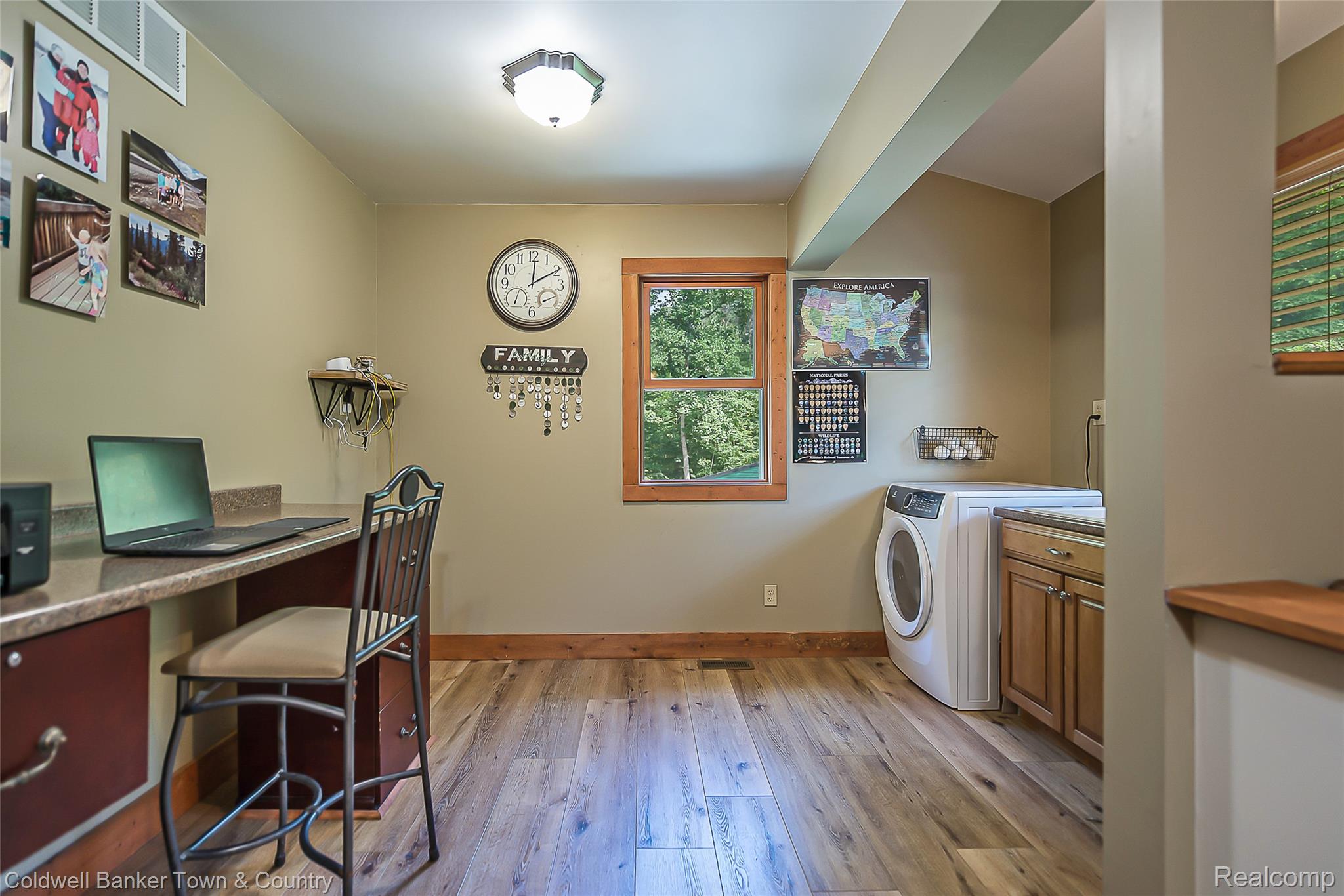 7023 Munsell Road Howell, MI 48843 - Photo 34 of 55 Integrated workspace with built-in desk and cabinetry, wood-finish flooring, and natural wood window trim