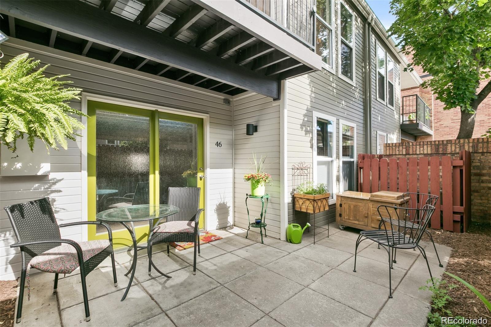 1150 Inca Street, Unit 46 Denver, CO 80204 - Photo 21 of 45 a view of a patio with table and chairs and potted plants