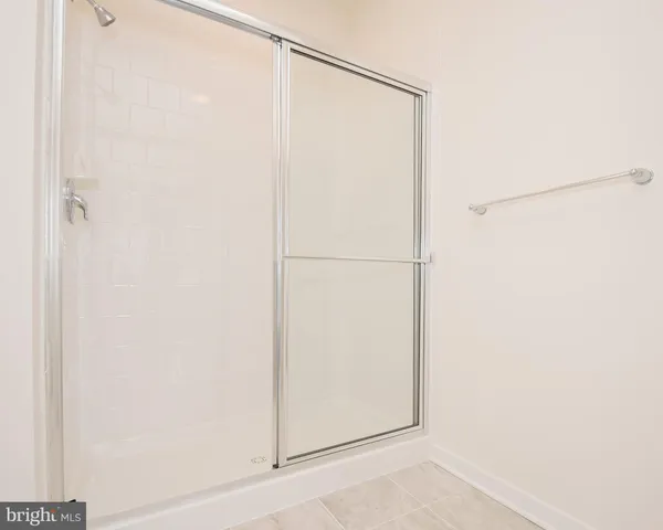 a bathroom with a glass shower door