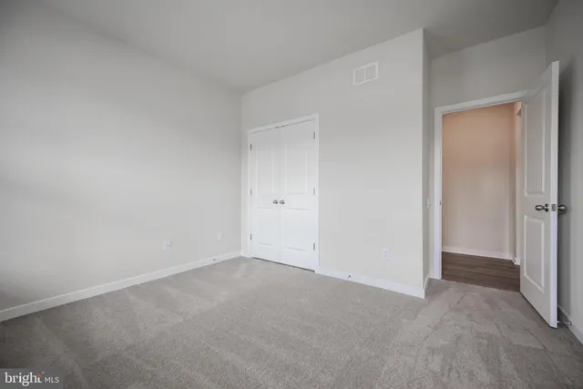 a front view of a house with a garden and yard