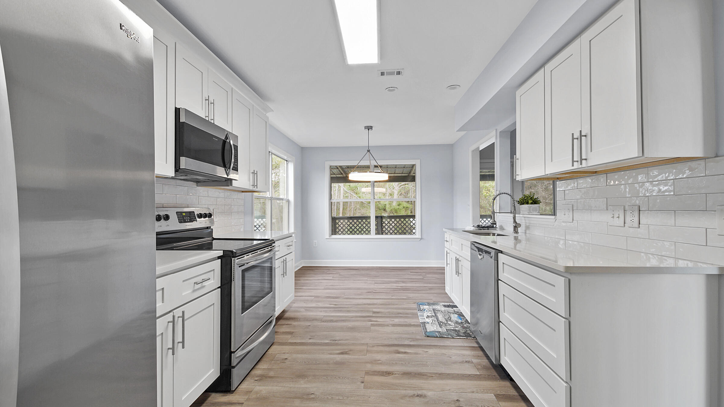 1190 Bay Court Destin, FL 32541 - Photo 13 of 52 a kitchen with stainless steel appliances granite countertop a stove top oven a sink dishwasher a refrigerator and a microwave oven with white cabinets