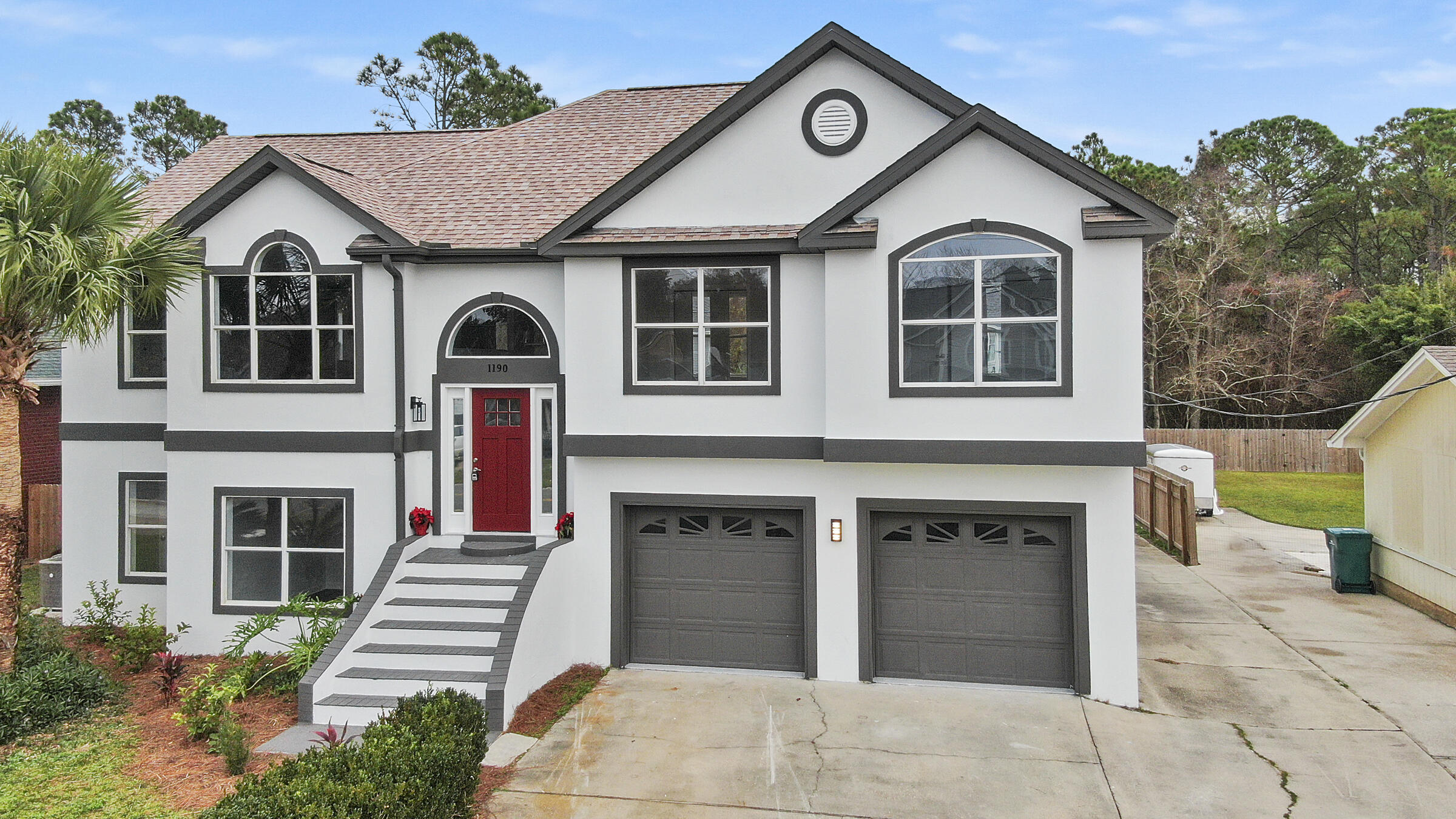 1190 Bay Court Destin, FL 32541 - Photo 2 of 52 a front view of a house with a yard