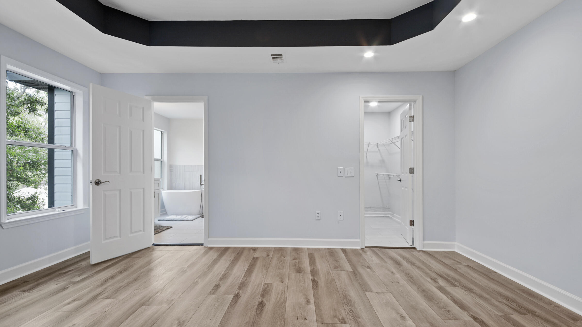 1190 Bay Court Destin, FL 32541 - Photo 26 of 52 an empty room with wooden floor and windows