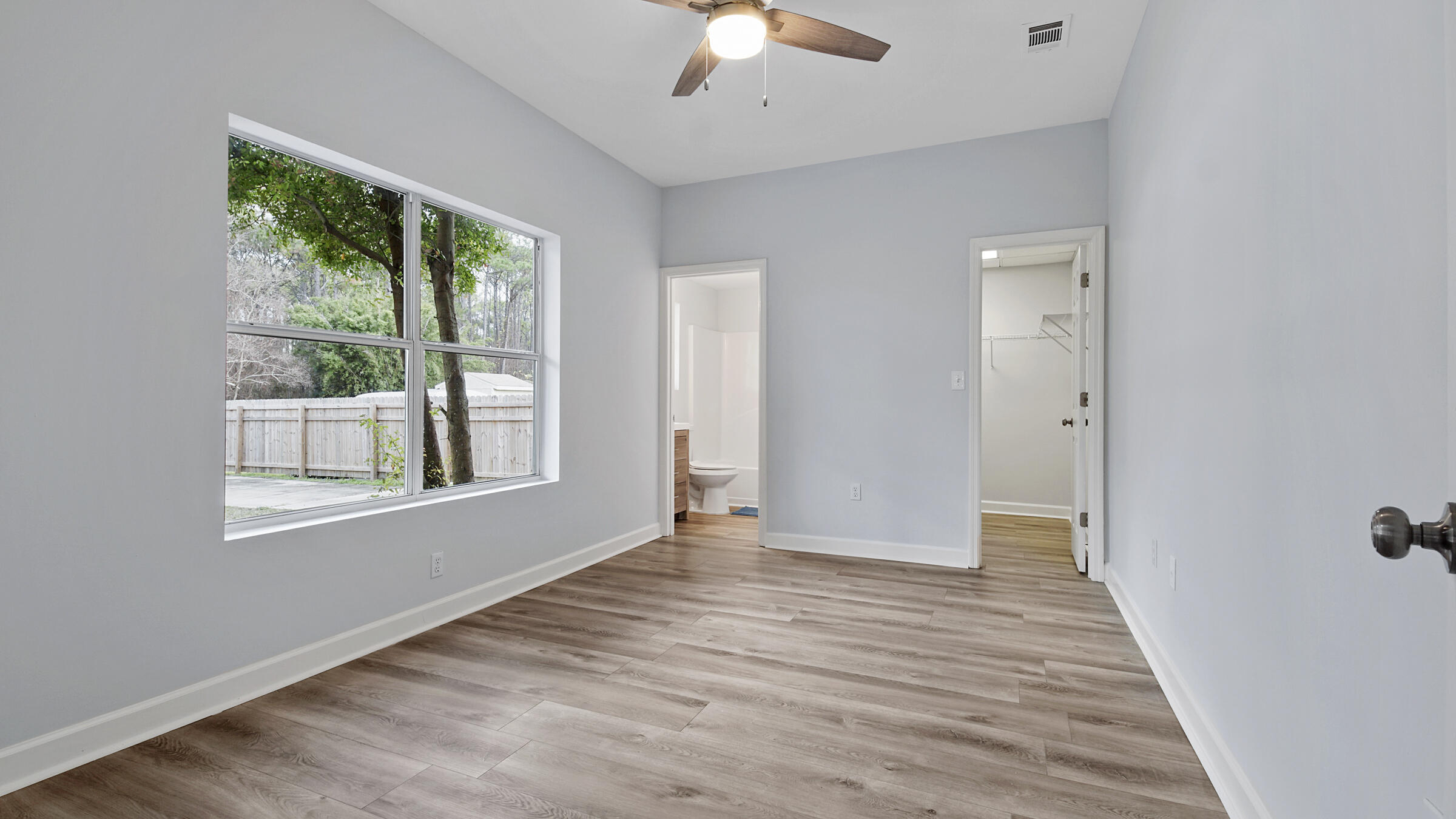 1190 Bay Court Destin, FL 32541 - Photo 38 of 52 a view of an empty room with wooden floor and a window
