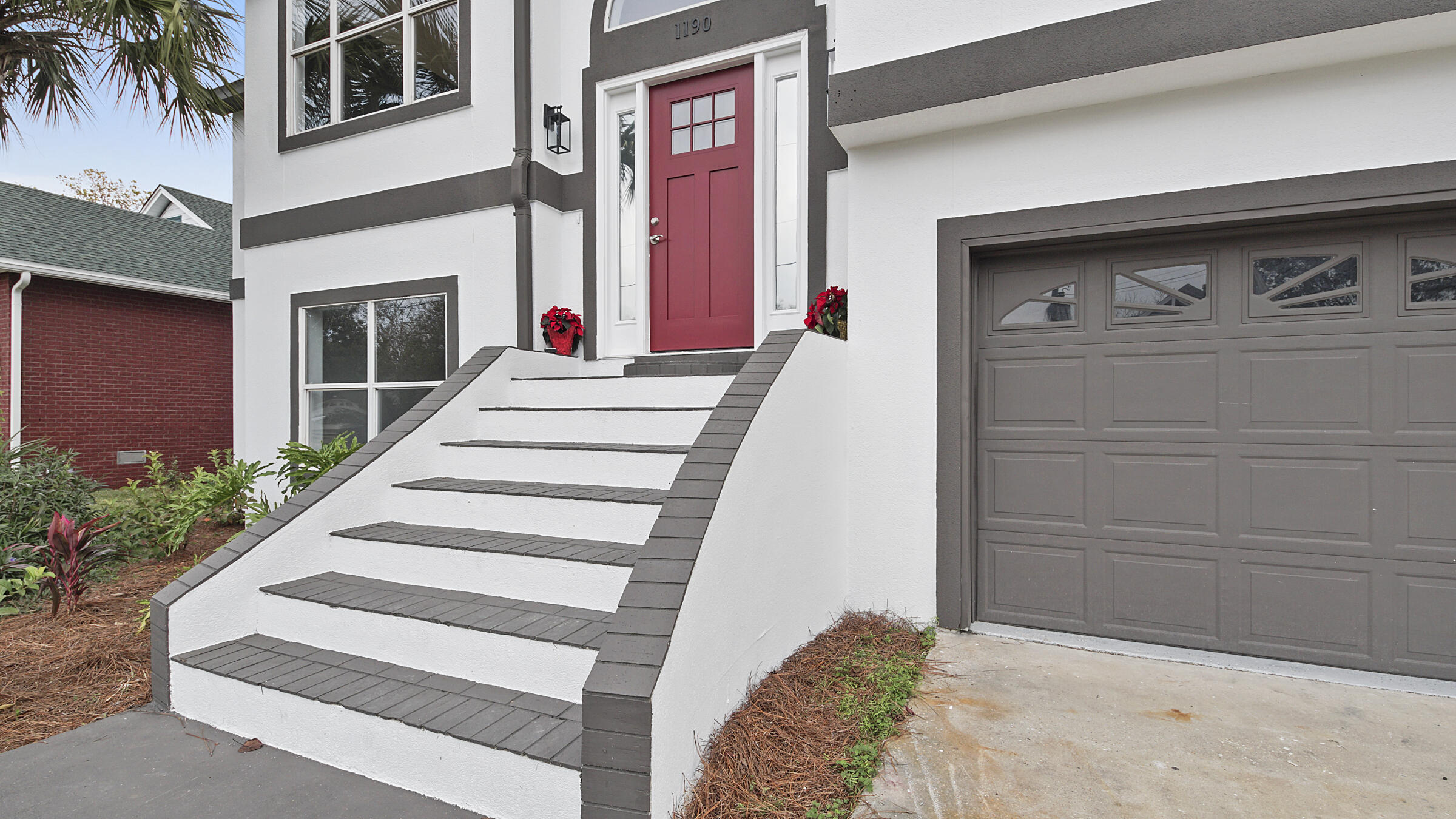 1190 Bay Court Destin, FL 32541 - Photo 7 of 52 a front view of a house with entryway