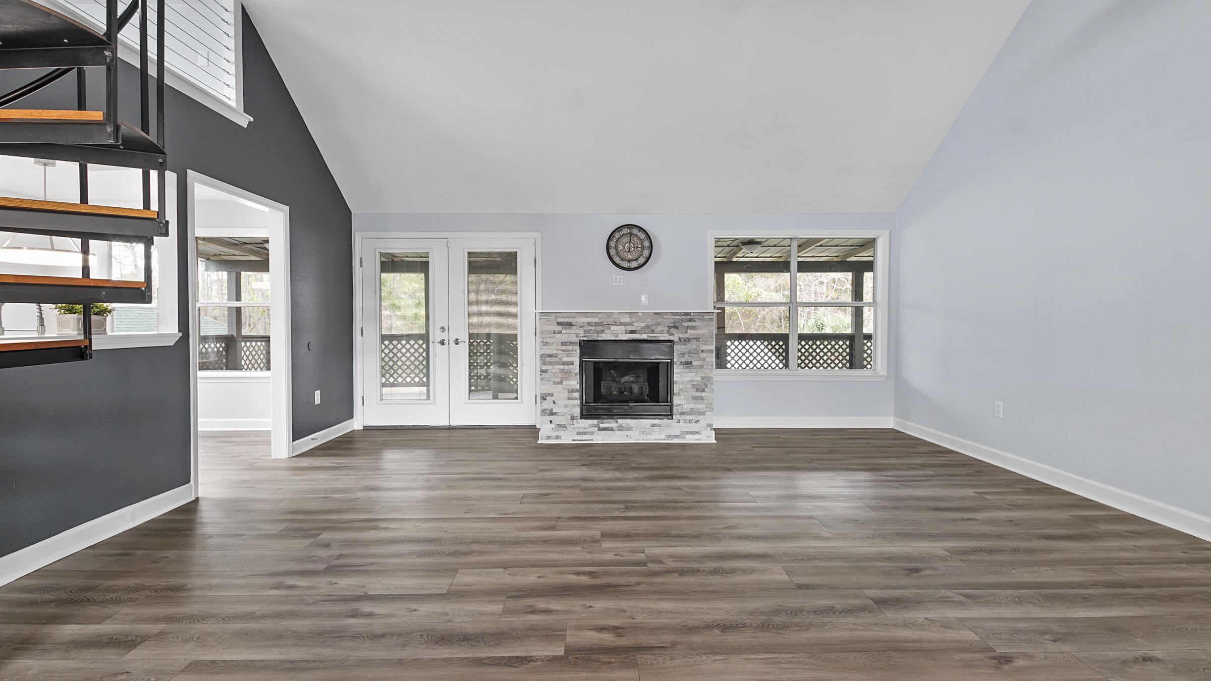 1190 Bay Court Destin, FL 32541 - Photo 9 of 52 an empty room with wooden floor fireplace and windows