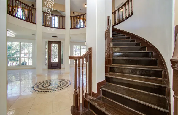 a view of a living room and chandelier fan