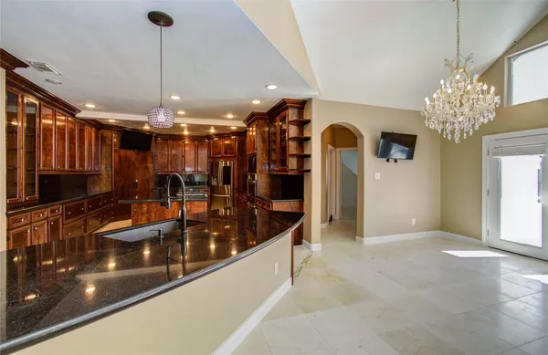 a large kitchen with stainless steel appliances and large cabinets