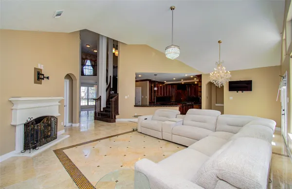 a living room with furniture and a chandelier