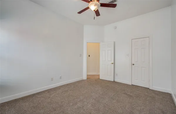 an empty room with windows and closet