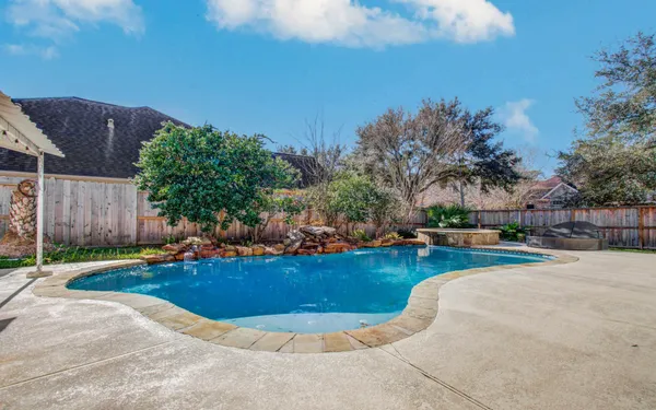 a view of a swimming pool with a patio