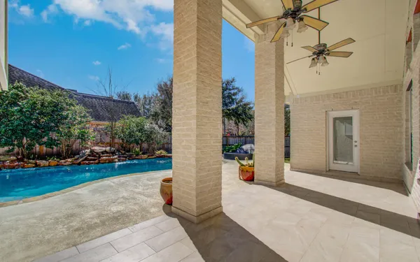 a backyard of a house with table and chairs
