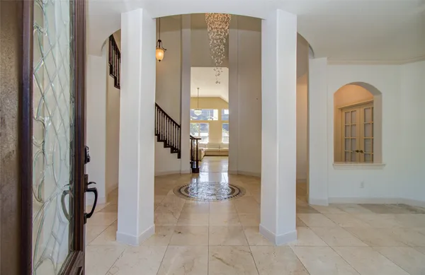 a view of a hallway with wooden floor windows and a livingroom