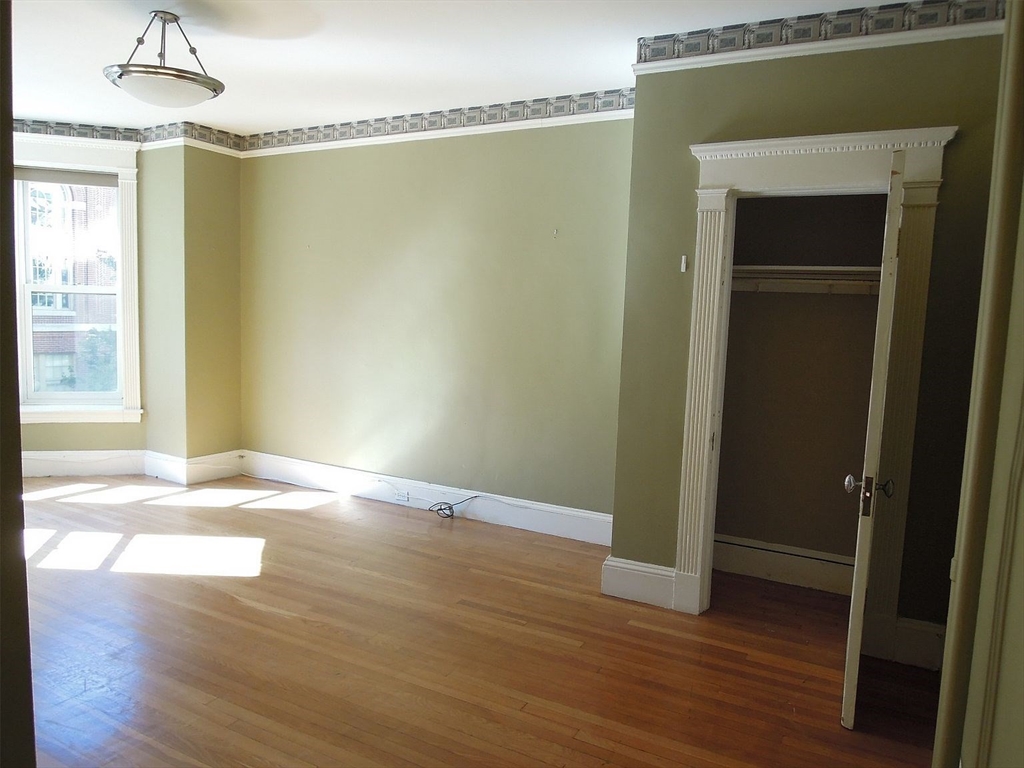 8 Garrison Street, Unit 209 Boston, MA 02116 - Photo 18 of 33 a view of empty room with wooden floor and fan
