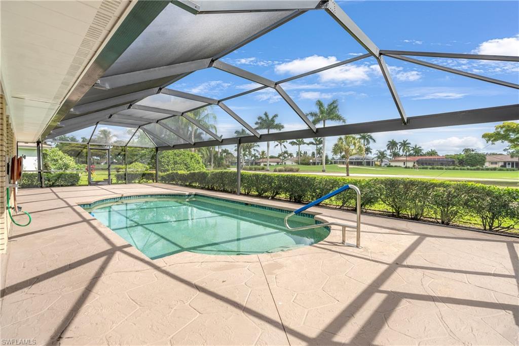 313 Forest Hills Boulevard Naples, FL 34113 - Photo 1 of 14 a view of a swimming pool with a porch