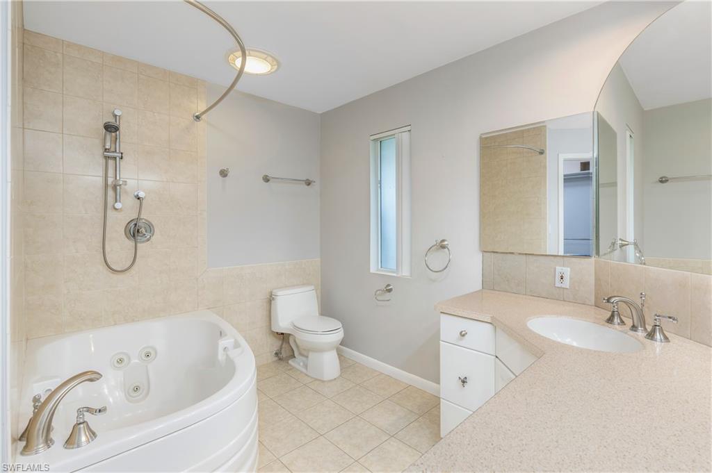 313 Forest Hills Boulevard Naples, FL 34113 - Photo 11 of 14 a bathroom with a sink a toilet and a bathtub