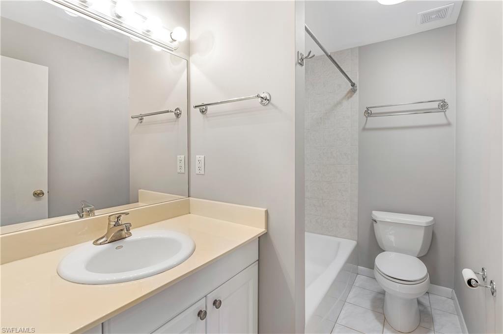 313 Forest Hills Boulevard Naples, FL 34113 - Photo 12 of 14 a bathroom with a sink toilet and shower