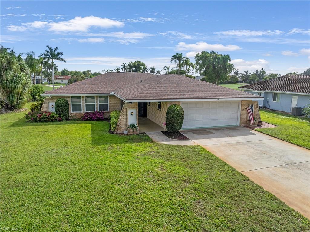 313 Forest Hills Boulevard Naples, FL 34113 - Photo 2 of 14 a view of a house with a yard
