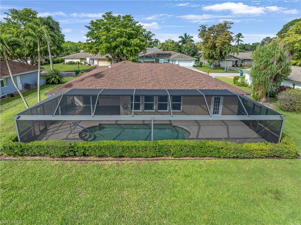 313 Forest Hills Boulevard Naples, FL 34113 - Photo 3 of 14 a house with a garden