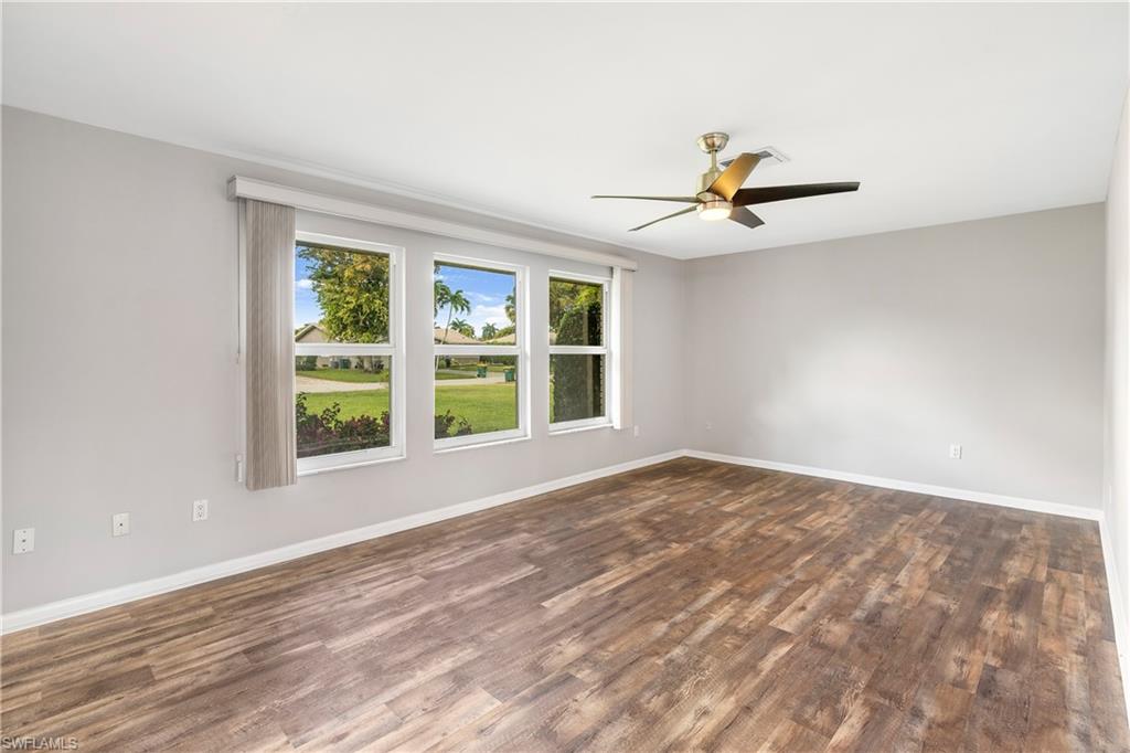 313 Forest Hills Boulevard Naples, FL 34113 - Photo 7 of 14 a view of an empty room with a window and a ceiling fan