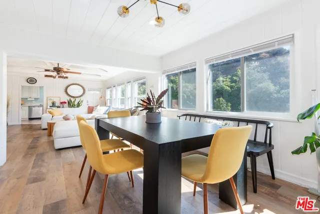 a dining room with furniture and wooden floor