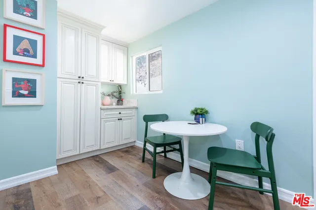 a view of a room with furniture and wooden floor