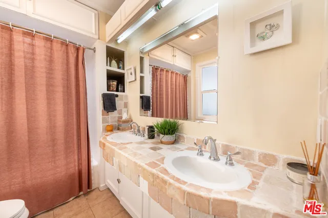 a bathroom with a double vanity sink and a mirror