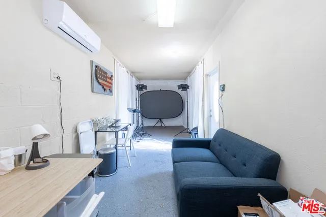 a living room with furniture and a lamp