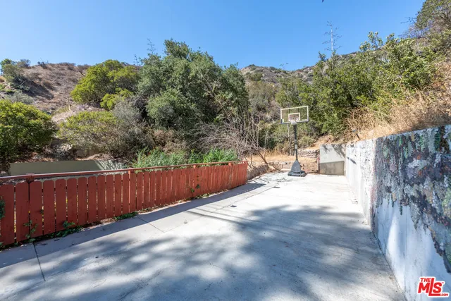 a view of a backyard with large trees