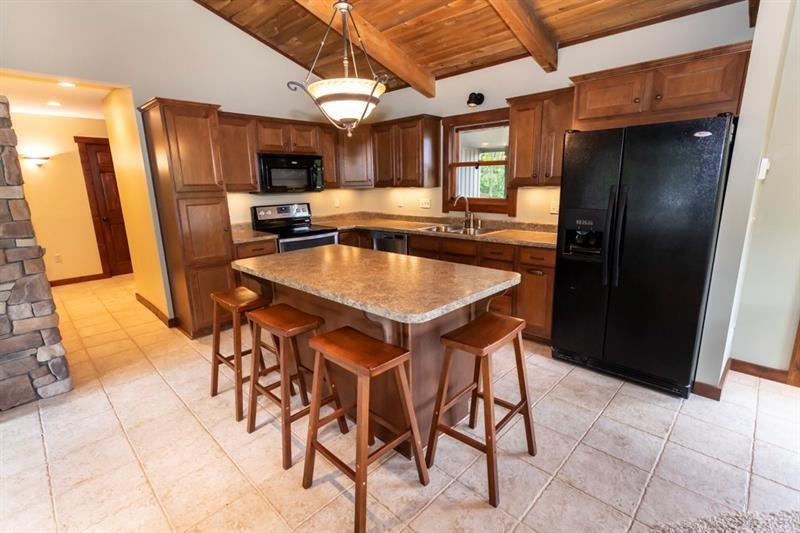 2226 County Line Road Champion, PA 15622 - Photo 7 of 33 a kitchen with stainless steel appliances granite countertop a table chairs sink and refrigerator