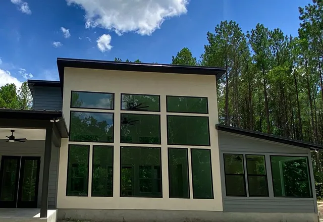 an aerial view of a house with a yard