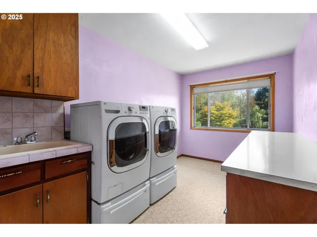a kitchen with a sink a washer and dryer