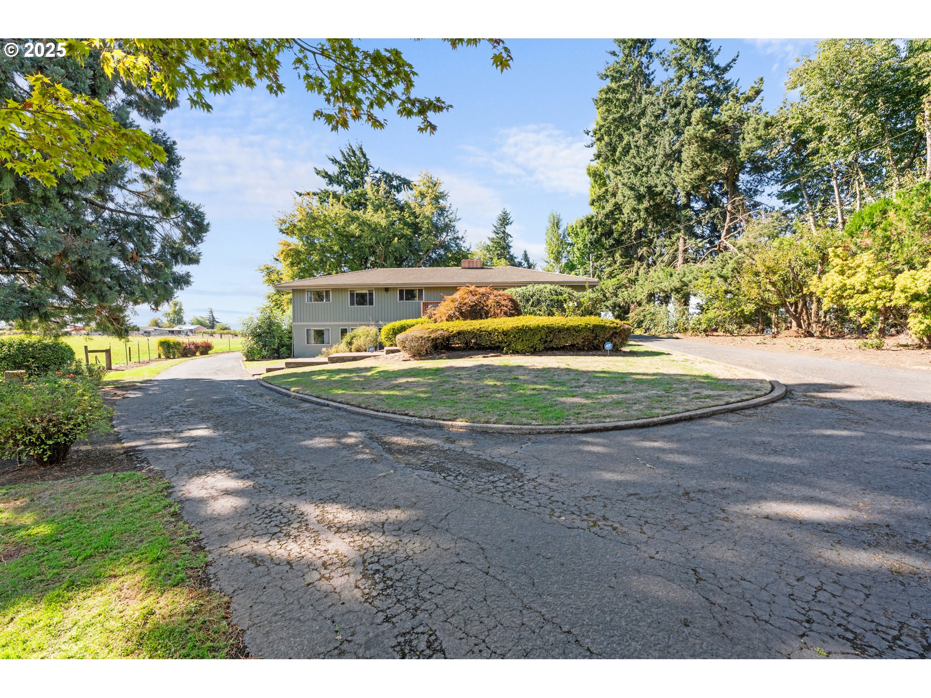 15895 Old Butteville Road Northeast Woodburn, OR 97071 - Photo 2 of 47 a view of a yard with yellow house