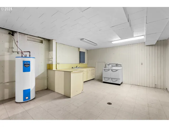 a utility room with cabinets and washer