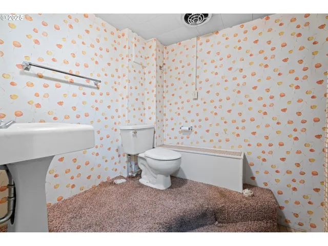 a bathroom with a toilet and a shower curtain