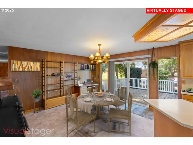 a living room with furniture a chandelier and a large window