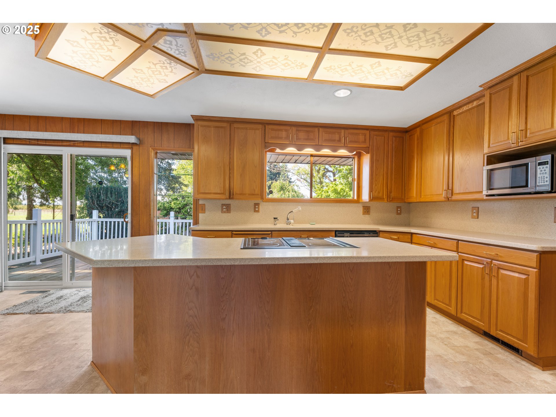 15895 Old Butteville Road Northeast Woodburn, OR 97071 - Photo 7 of 47 a kitchen with stainless steel appliances granite countertop a stove a sink and a microwave