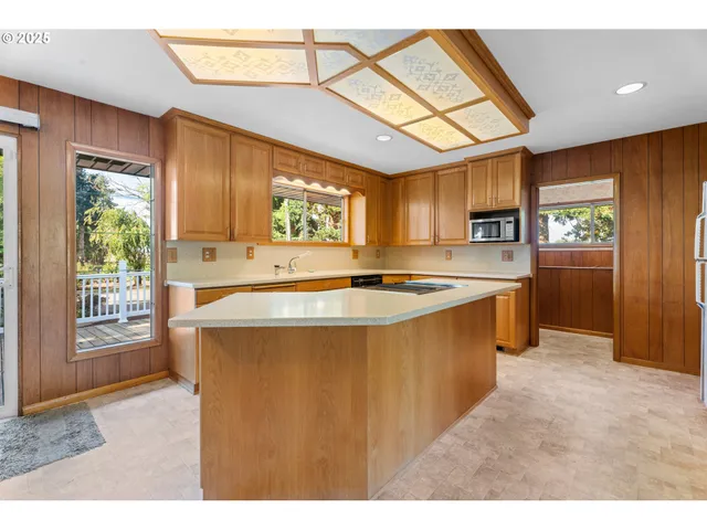 a kitchen with stainless steel appliances granite countertop a sink a stove and a refrigerator