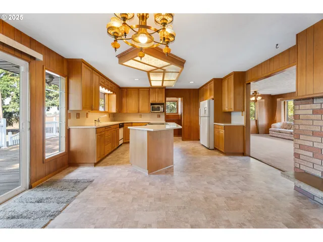 a kitchen with stainless steel appliances granite countertop a stove a sink dishwasher and a refrigerator