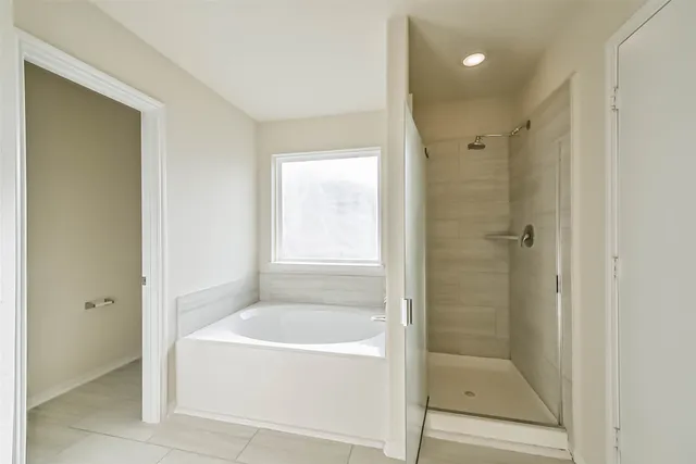 a white bath tub sitting next to a shower