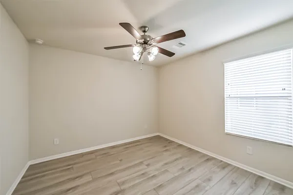 wooden floor in an empty room with a window