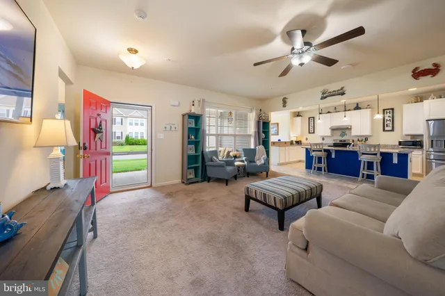 a kitchen with stainless steel appliances a table chairs sink refrigerator and cabinets